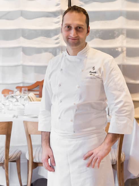 Portrait photo of Executive Pastry Chef Daniele Bonzi standing in white uniform