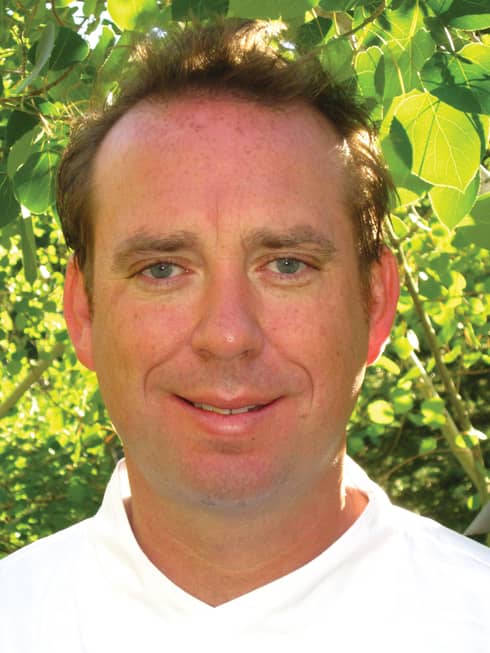 Portrait photo of Executive Chef Michael Goralski in front of trees