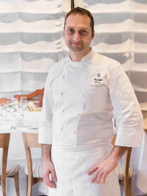 Portrait photo of Executive Pastry Chef Daniele Bonzi standing in white uniform