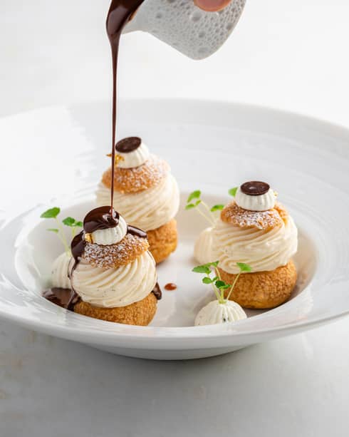 Profiteroles, vanilla ice cream and chocolate sauce