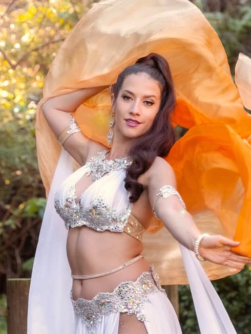 A dance artist wearing a costume with jewels