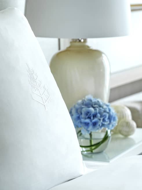 Four Seasons bed, nightstand with lamp, and two-seat sofa