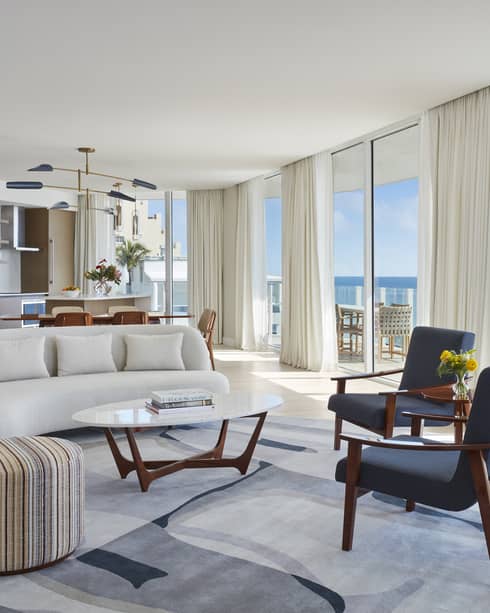 Living room and dining room with wall of windows, ocean view