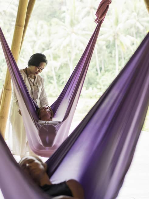 Guests taking a sacred nap in hanging fabric swings