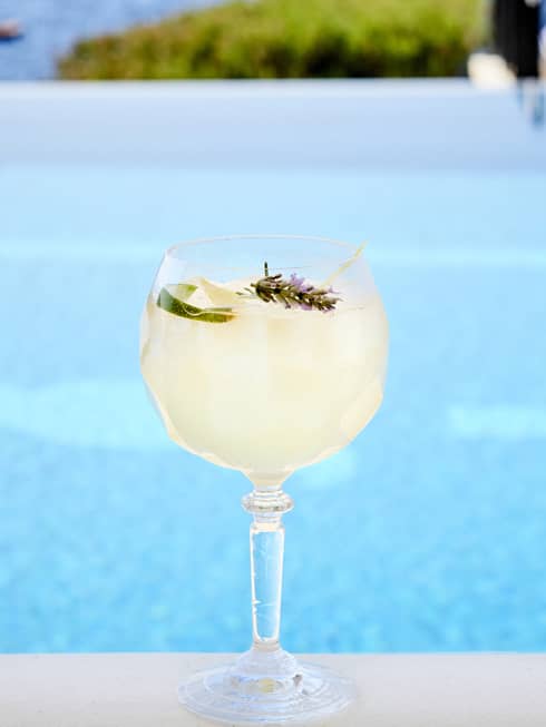 A Club Spritz cocktail in front of a pool