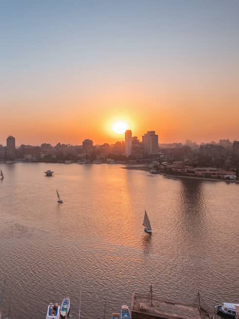 Sunset over Nile River with sailboats in Cairo, Egypt