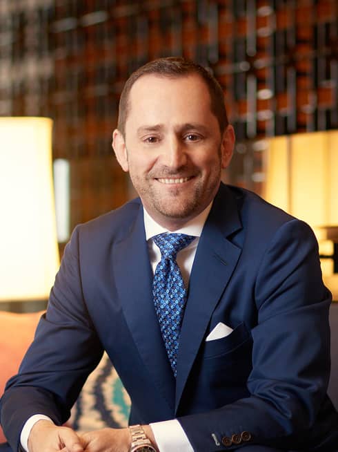 Portrait photo of Hotel Operations Europe, Middle East and Africa President Simon Casson wearing suit, tie