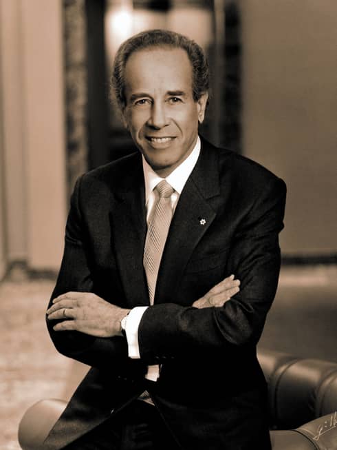 Portrait photo of Four Seasons Hotel Founder and Chairman Isador Sharp wearing suit, tie