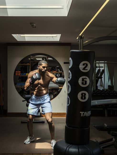 A man practicing boxing in a dark room