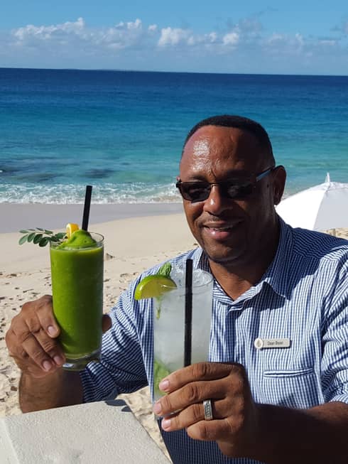 Dean Bryan, Assistant Manager of Half Shell Beach Bar holds up two icy cocktails