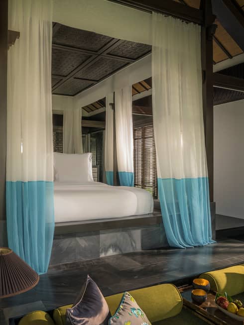 Villa raised platform poster bed with white-and-blue gossamer drape canopy