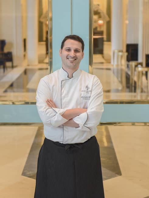 Portrait photo of smiling Executive Pastry Chef Lorenzo Sollecito wearing uniform