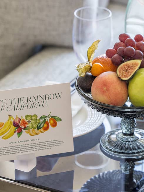 Fruit plate on a side table next to a sofa in luxury hotel suite
