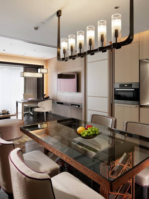 Residence dining table, fruit bowl under candle chandelier, modern kitchen, living room