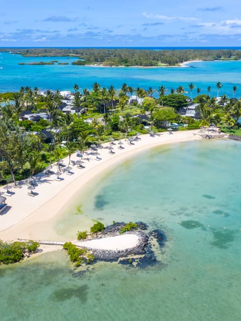 Aerial view of Four Seasons Resort Mauritius at Anahita and surroundings, including white-sand crescent beach and ocean