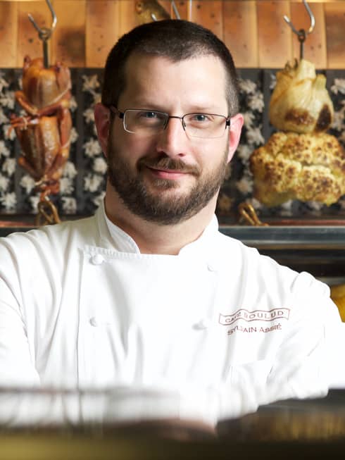 Portrait photo of Chef de Cuisine Sylvain Assié wearing uniform