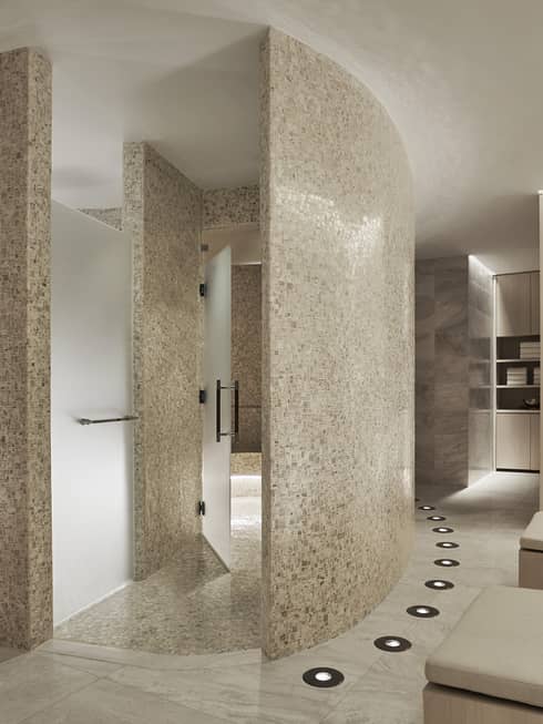 Curved white stone walls in Spa locker room, wood lockers 