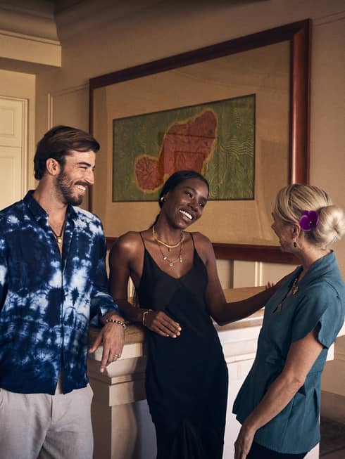 Three people talk at Four Seasons Resort Maui