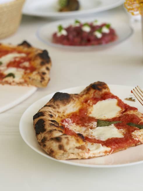 Pizza on white plates.