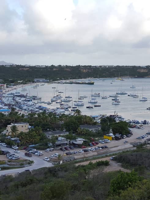 Aerial view of a busy harbour with sails and boats in Anguilla, cloudy skies