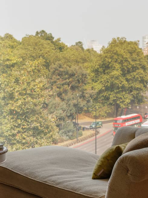 Chaise longue facing a window, overlooking London city street and park