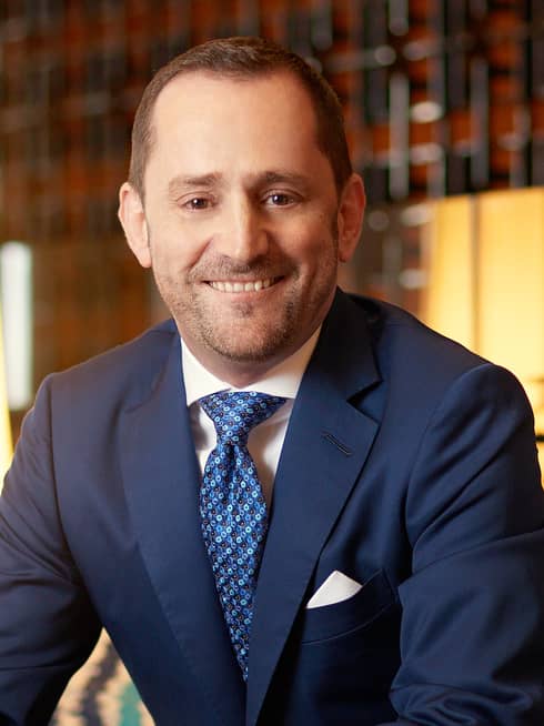 Portrait photo of Hotel Operations Europe, Middle East and Africa President Simon Casson wearing suit, tie