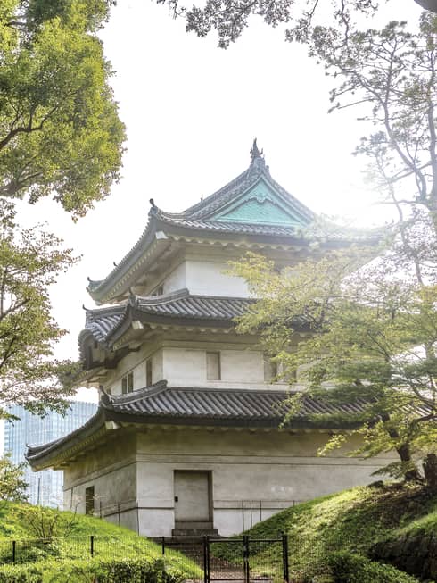 Traditional Japanese building with tiered roofs surrounded by trees
