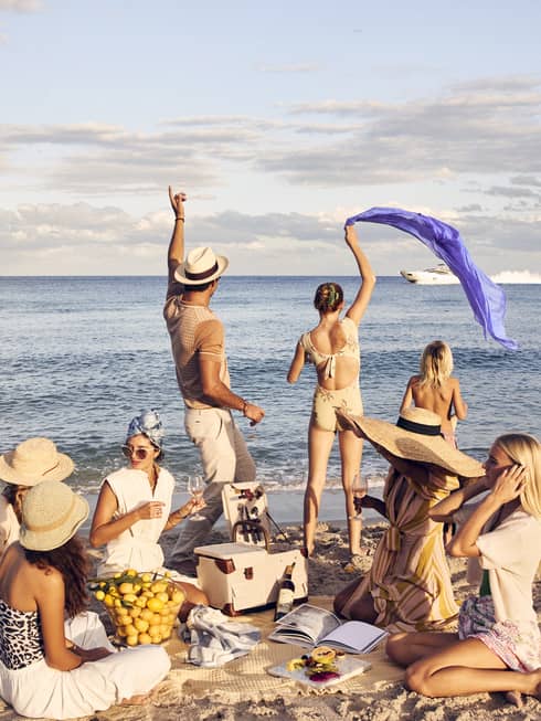 A group of people having a picnic on a beach.