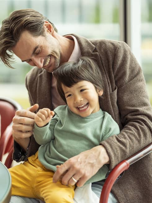 Laughing couple and kids enjoy a meal together