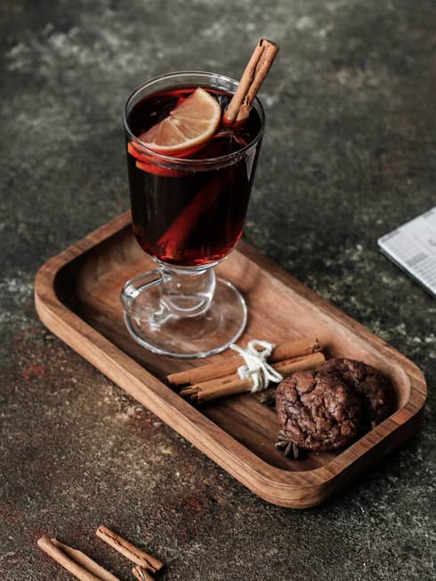 Glass of mulled wine with cinnamon stick and orange slice