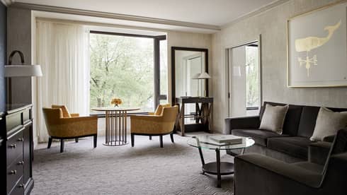 Luxury hotel room and honeymoon suite with orange armchairs and modern decor