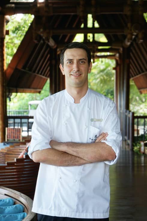 A portrait of Chef Fabian, crossing his arms over his chef shirt