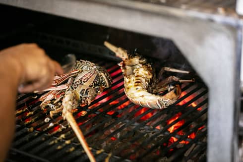 Seafood being cooked on a grill.
