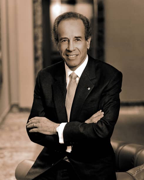 Portrait photo of Four Seasons Hotel Founder and Chairman Isador Sharp wearing suit, tie