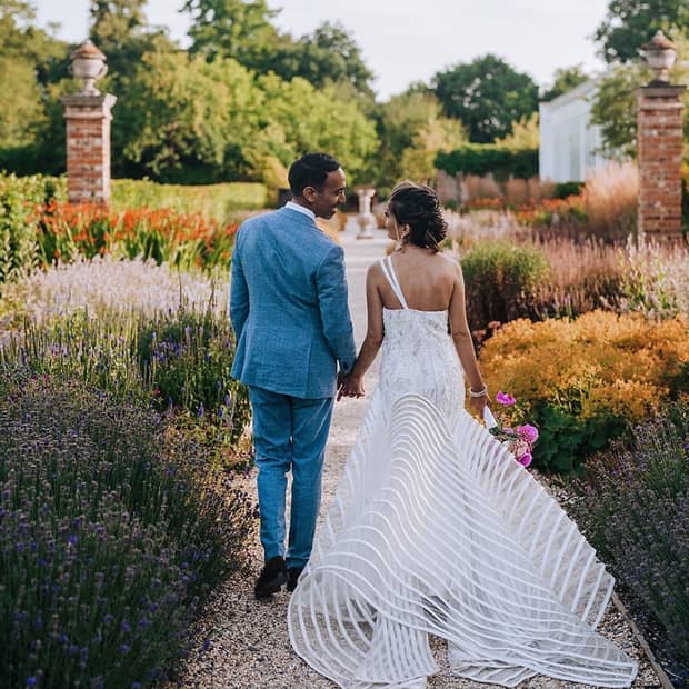 A couple leisurely walking through captivating gardens