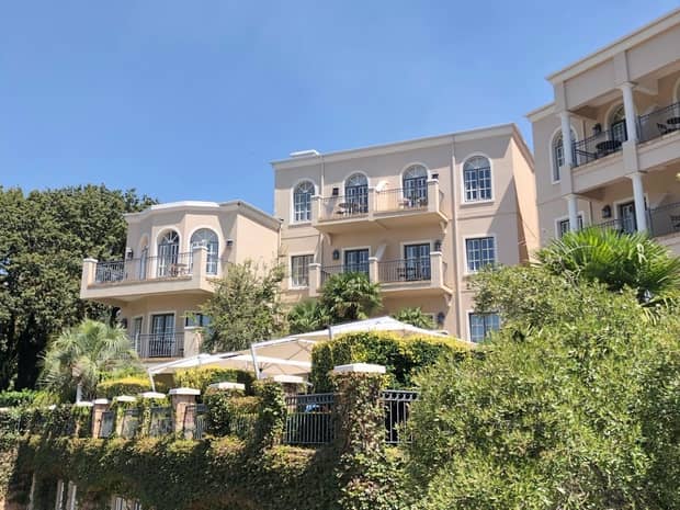 Hotel exterior, balconies over tropical gardens 