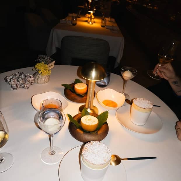 An overview shot of a restaurant table in softly illuminated surroundings.