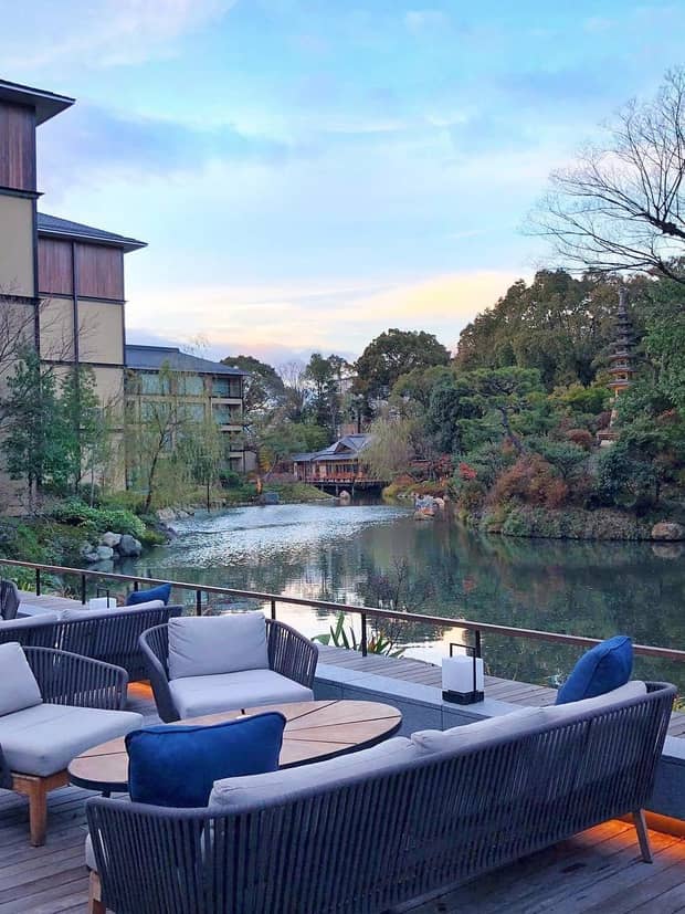 Patio seating area by pond, building