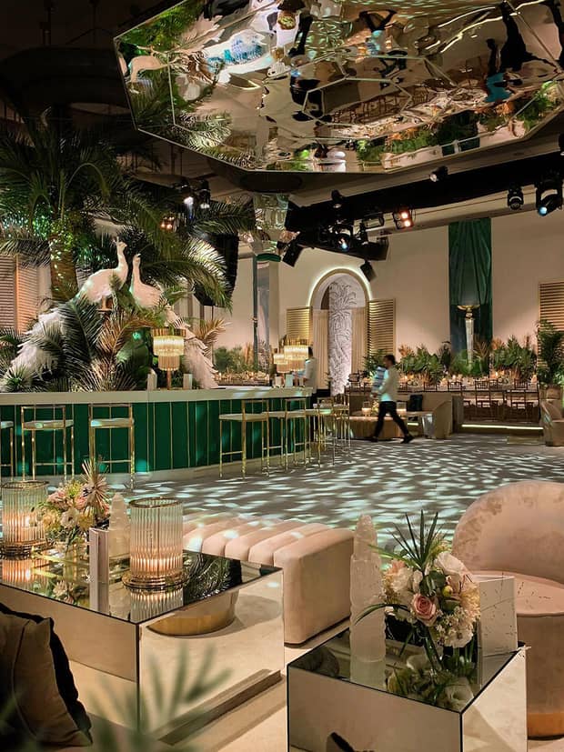 Wedding reception event room seating area, bar with white birds decor, mirror over dance floor