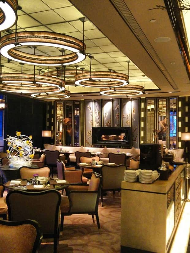 Lounge tables and chairs under ceiling with modern circular lights 