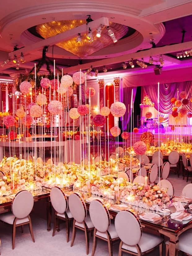 Large tables with flowers and decorations covering them.