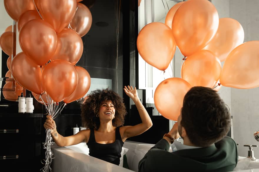 Man and woman playing with balloons
