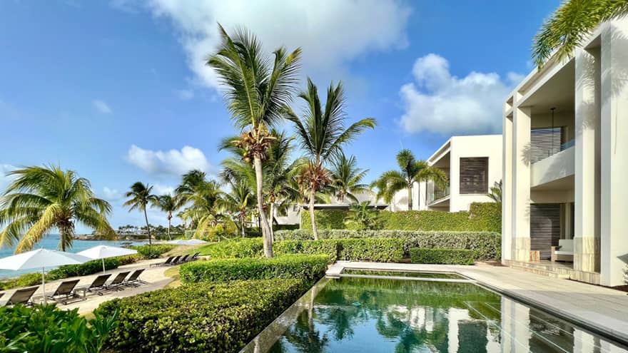 A private outdoor infinity pool overlooks a beach and ocean view