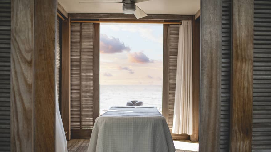Massage table in room with view of the water.