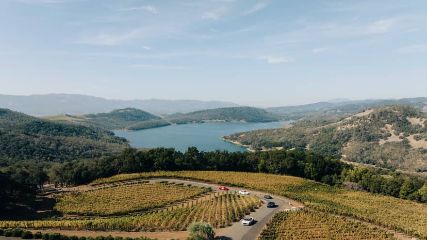 Aerial view of cars driving through a vineyard in Napa Valley