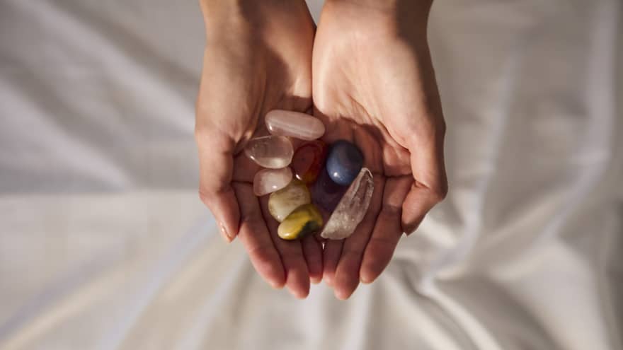 A person holds several smooth stones cupped in their two hands.