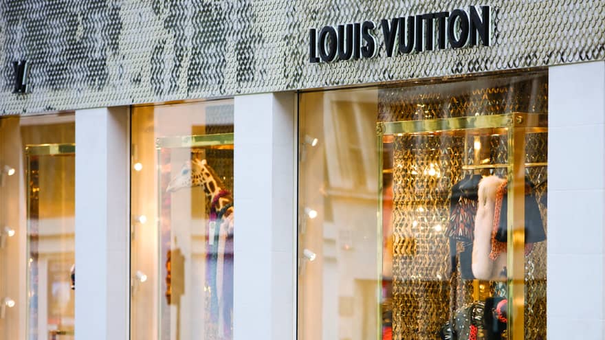 Window of Louis Vuitton displaying giraffe and clothing