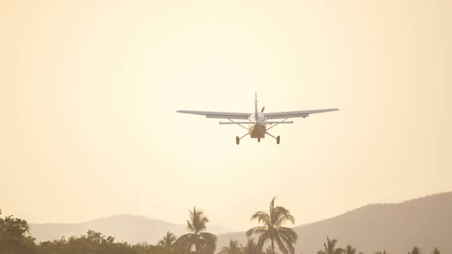 Airplane lands in tropical setting
