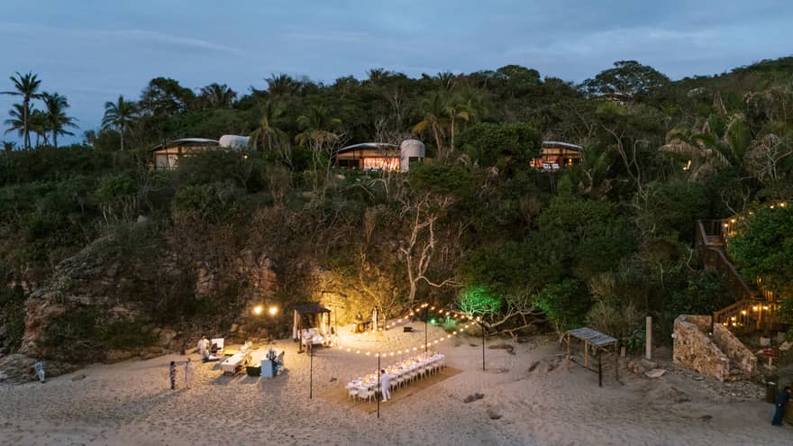 Aerial view of beach group dinner setup