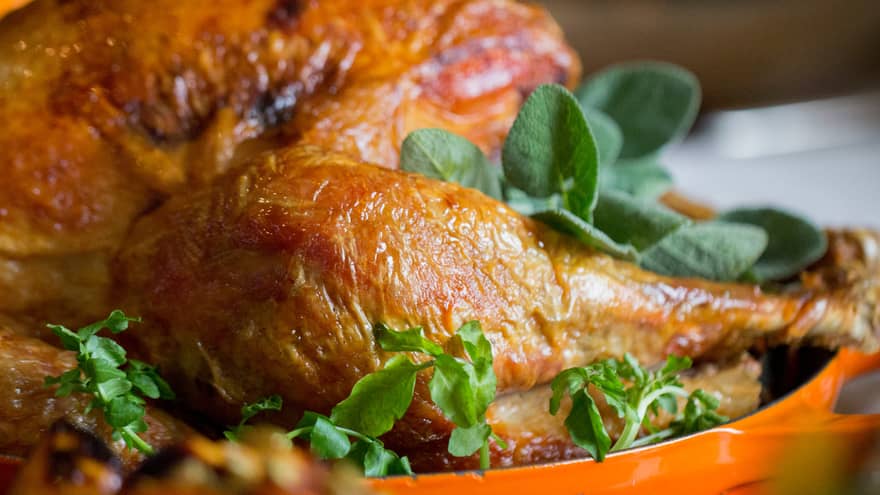 Golden whole roast turkey with fresh herbs